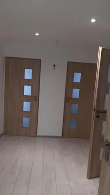 an empty room with two doors and a tile floor at Pokoje do wynajęcia w domku