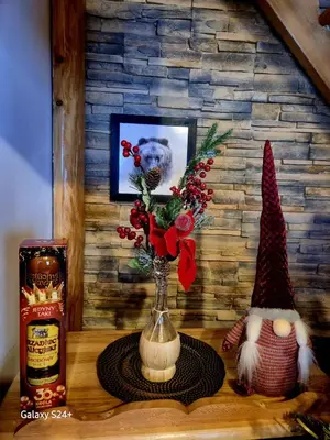 a vase with flowers in it sitting on a table at Domek pod Babią Górą in Zawoja