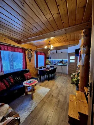 a living room with a couch and a table at Domek pod Babią Górą in Zawoja