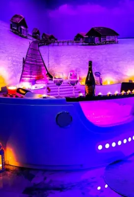 a sauna with a walk in shower with wooden walls at Jacuzzi-Sauna apartament in Kraków