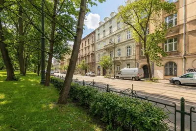 a street in a city with trees and a fence at Klimatyczne Studio obok Starego Miasta by Noclegi Renters in Kraków