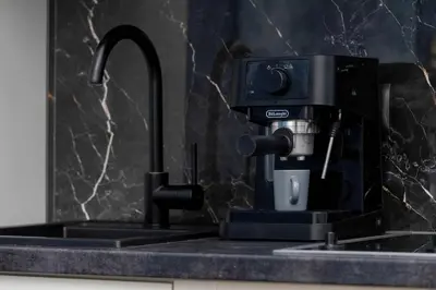 a coffee machine sitting on top of a kitchen sink at Klimatyczne Studio obok Starego Miasta by Noclegi Renters in Kraków