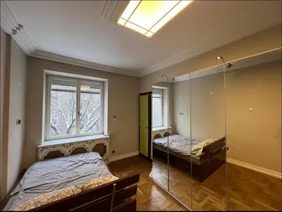 a bedroom with two beds and a window at Affordable place in city center in Kraków