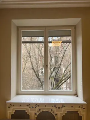 a desk and a chair in a room with a door at Affordable place in city center in Kraków