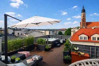 a living room with a table and a couch at Old Town Apartment with Private Rooftop Jacuzzi and the Sky Views ! Balcony AC WiFi Parking in Kraków