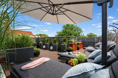a kitchen and living room with a bowl of fruit on a table at Old Town Apartment with Private Rooftop Jacuzzi and the Sky Views ! Balcony AC WiFi Parking in Kraków