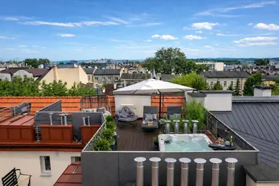a house with a balcony with a heater at Old Town Apartment with Private Rooftop Jacuzzi and the Sky Views ! Balcony AC WiFi Parking in Kraków