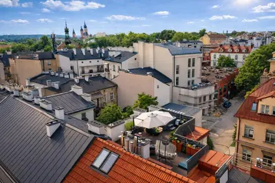 a kitchen with white cabinets and fruit on a counter at Old Town Apartment with Private Rooftop Jacuzzi and the Sky Views ! Balcony AC WiFi Parking in Kraków