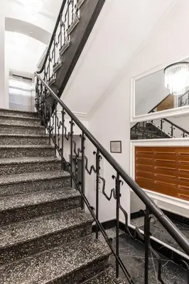 a staircase in a house with a chandelier at Old Town Apartment with Private Rooftop Jacuzzi and the Sky Views ! Balcony AC WiFi Parking in Kraków
