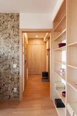 a bedroom with a wooden cabinet next to a window at Lan Apartament in Kraków