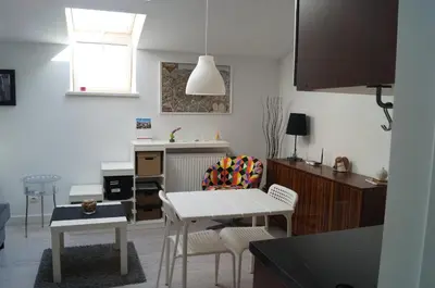a kitchen with a table and chairs in a room at Apartament Ariańska in Kraków