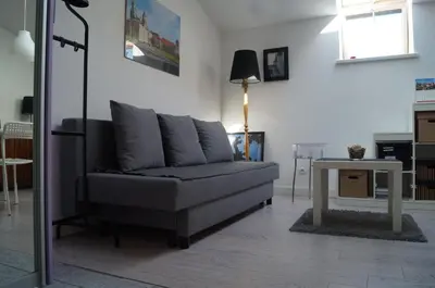 a living room with a couch and a table at Apartament Ariańska in Kraków
