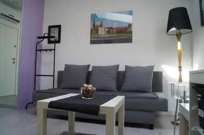 a living room with a couch and a table at Apartament Ariańska in Kraków