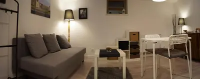 a living room with a couch and a table at Apartament Ariańska in Kraków