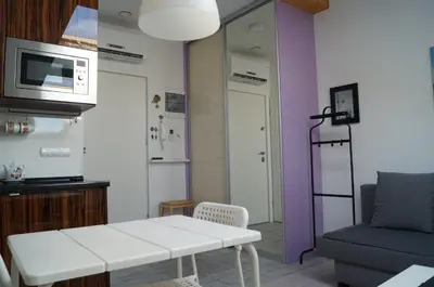 a living room with a white table and a couch at Apartament Ariańska in Kraków