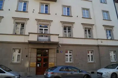 two cars parked in front of a building at Apartament Ariańska in Kraków