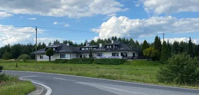 a house sitting on the side of a road at Zajazd Maj in Bolesław
