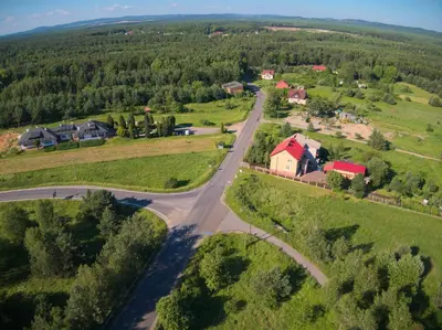 an aerial view of a village with a road and houses at Zajazd Maj in Bolesław