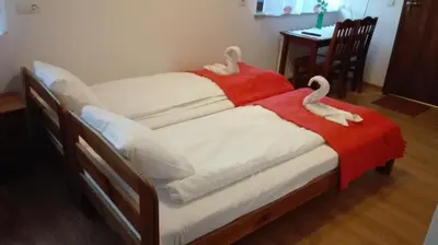 a bed with two swans on top of it at Willa Julia in Kraków