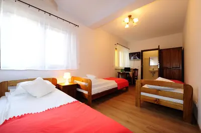 a hotel room with two beds and a window at Willa Julia in Kraków