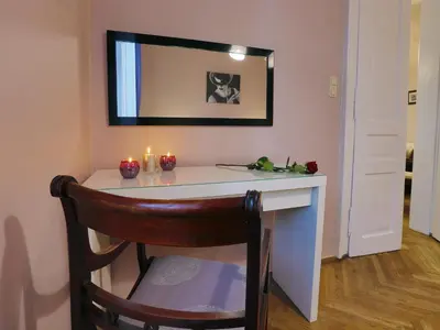 a room with a desk with candles and a mirror at AR Apartments in Kraków