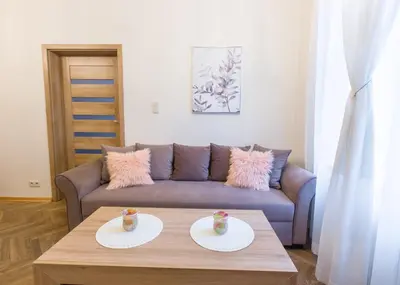 a living room with a couch and a coffee table at AR Apartments in Kraków