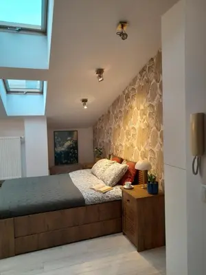 a bedroom with a bed and a wall at Old Town Premium Apartment Kazimierz - Synagogue view in Kraków