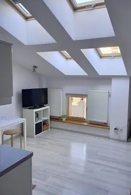 an empty living room with skylights in the ceiling at Old Town Premium Apartment Kazimierz - Synagogue view in Kraków