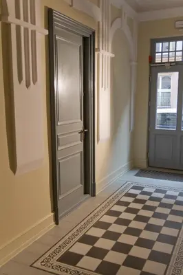 a room with a door and a checkered floor at Old Town Premium Apartment Kazimierz - Synagogue view in Kraków