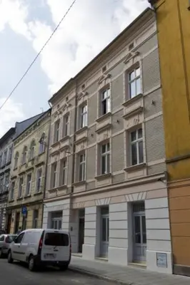 a white van parked in front of a building at Old Town Premium Apartment Kazimierz - Synagogue view in Kraków