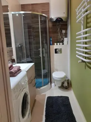 a bathroom with a shower and a washing machine at Old Town Premium Apartment Kazimierz - Synagogue view in Kraków