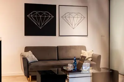 a living room with a couch and a table at Diamonds Apartment in Kraków