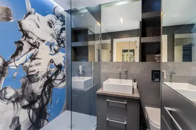 a bathroom with a sink and a mirror at Diamonds Apartment in Kraków