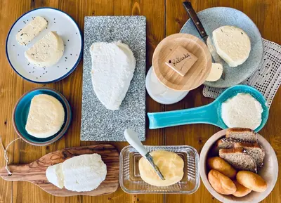 a table topped with different types of bread and other foods at Zagroda na Pacanach in Iwkowa