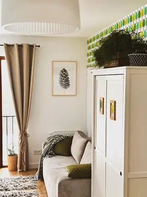 a living room with a couch and a cabinet at Zagroda na Pacanach in Iwkowa