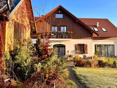 a house with a porch with a balcony at Zagroda na Pacanach in Iwkowa