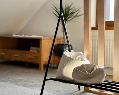 a purse sitting on a chair in a living room at Zagroda na Pacanach in Iwkowa