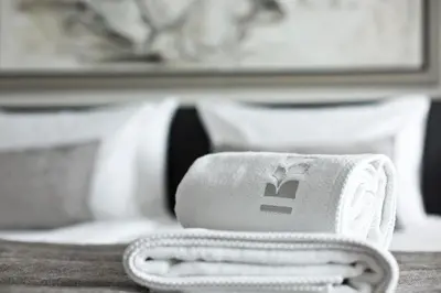 a white object with a logo on it sitting on a table at Benefis Boutique Hotel in Kraków