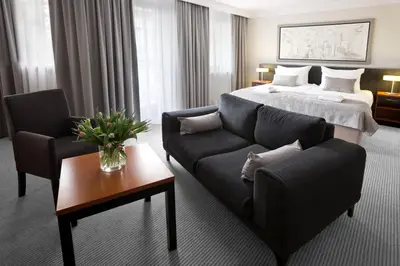 a hotel room with a bed and a couch at Benefis Boutique Hotel in Kraków