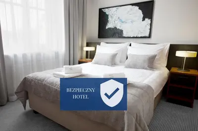 a hotel room with a bed with a sign on it at Benefis Boutique Hotel in Kraków