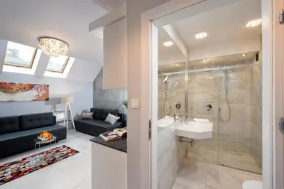a bathroom with a shower and a sink and a toilet at Elegant City Center Apartment in Kraków