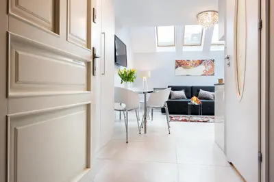 a bedroom with a bed and a couch at Elegant City Center Apartment in Kraków