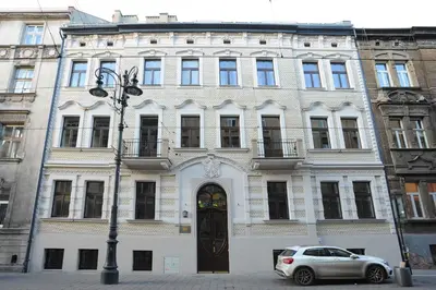 a window in a building with a stained glass window at Elegant City Center Apartment in Kraków