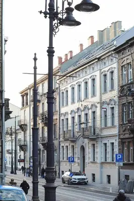 a city street with buildings and a street light at Elegant City Center Apartment in Kraków