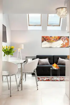 a bathroom with a sink and a bedroom with a bed at Elegant City Center Apartment in Kraków
