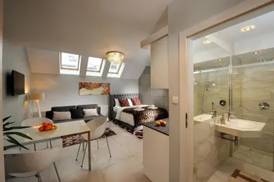 a bathroom with a shower and a sink and a toilet at Elegant City Center Apartment in Kraków