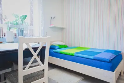 a small bedroom with a bed and a ladder at Apartament Franka in Oświęcim