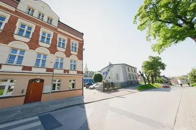 an empty street in a city with a building at Apartament Franka in Oświęcim