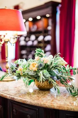 two white vases with plants in them on a table at Turówka Hotel & Spa in Wieliczka