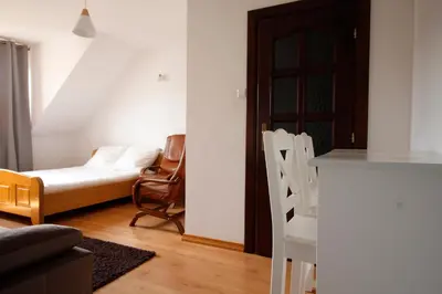a living room with a couch and a bed and a table at Willa Zofia in Rabka